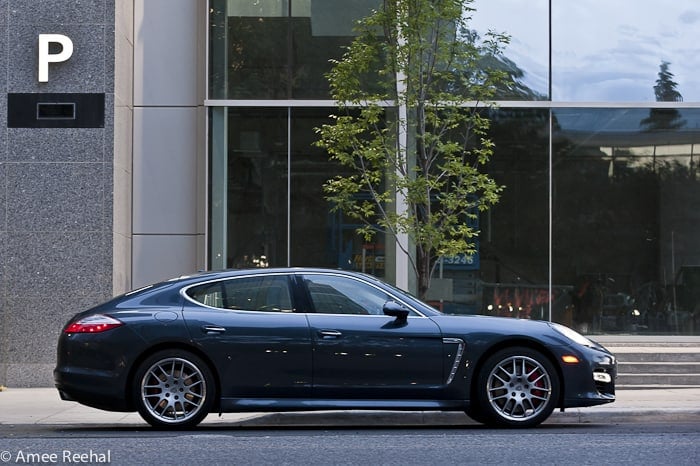 2010 Porsche Panamera Turbo sideview parked downtown on the street in front of glass building window