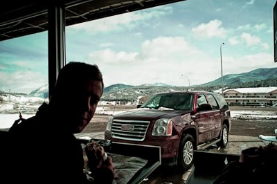 2009 GMC Yukon Hybrid parked outside while passengers each lunch