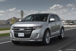 silver 2011 Ford Edge Sport front view driving on the road