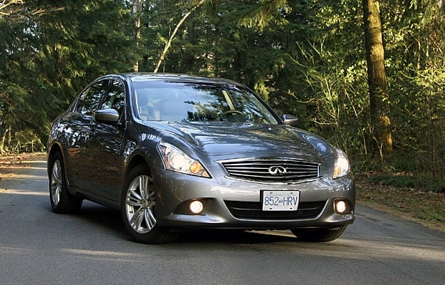 2011 Infiniti G25x parked on street with trees