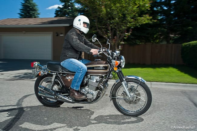 Honda CB750 K1 brown, black, and chrome riding by