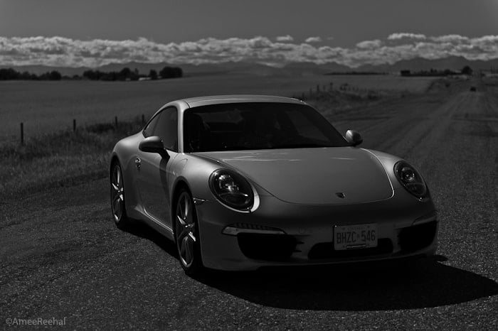 2012 Porsche 911 Carrera S front view in black and white parked on road