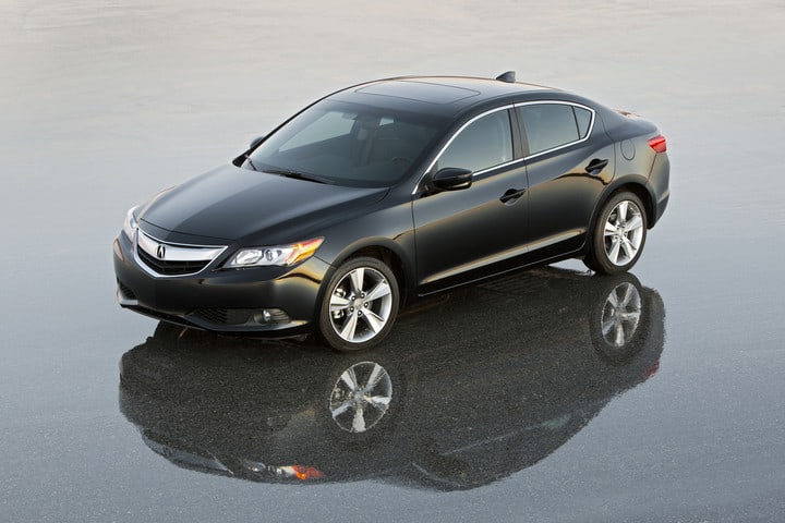 2015 Acura ILX Dynamic in black parked on pavement reflecting off the wet ground