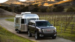 2016 GMC Yukon Denali in black towing an Airstream RV