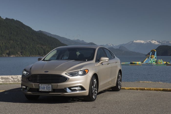 2017 Ford Fusion front view parked in front of lake and mountains