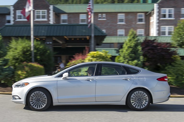 2017 Ford Fusion silver model driving by side view