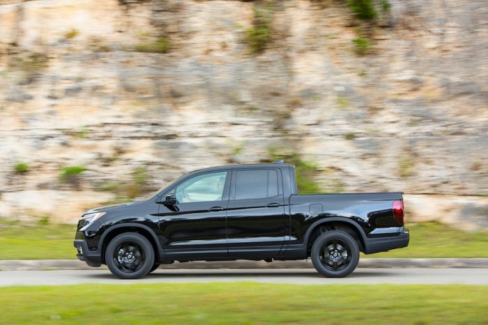 black 2017 Honda Ridgeline Black Edition driving by on the road