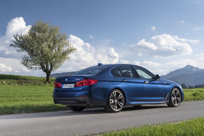 BMW M550i xDrive rear profile blue