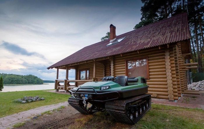 Tinger Track ATV in front of log cabin