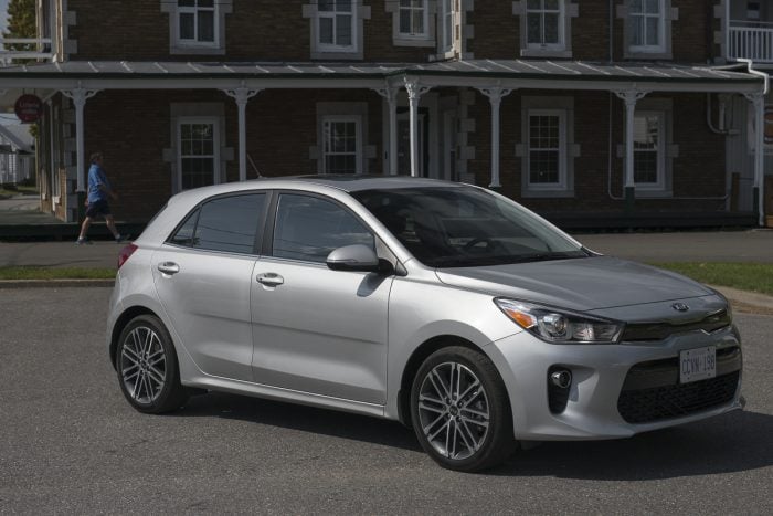 silver 2018 Kia Rio Hatchback parked on road in front of old Quebec building