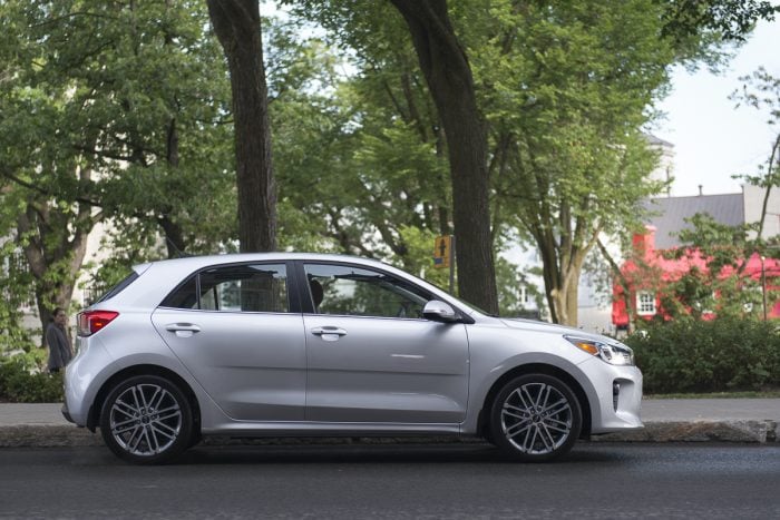 silver 2018 Kia Rio Hatchback sideview on the street in front of large tree