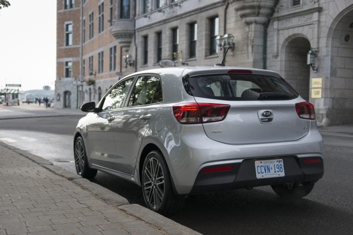 silver 2018 Kia Rio Hatchback rear profile parked on street in Quebec City