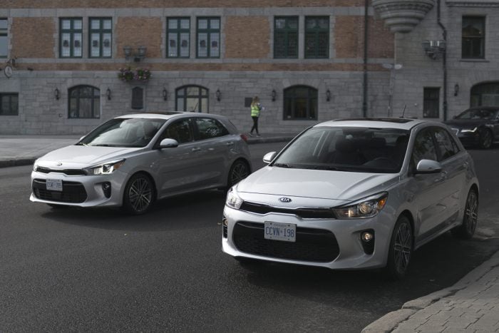 pair of silver 2018 Kia Rio Hatchback on the street