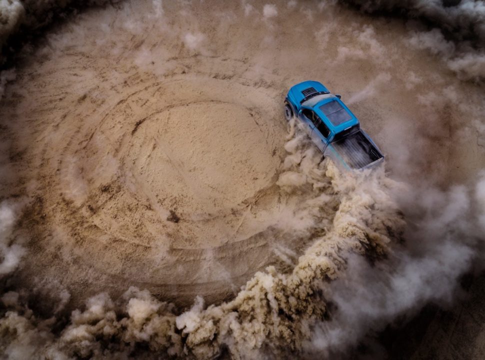 2019 Ford F-150 Raptor doing donuts in the sand