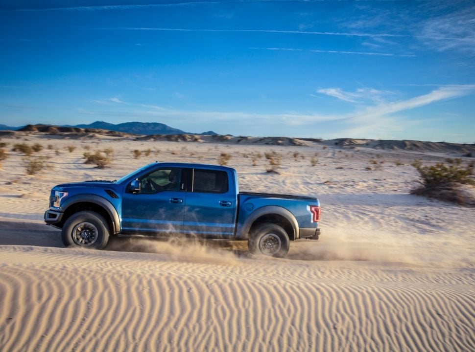 2019 Ford F-150 Raptor driving through the sand