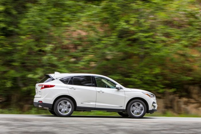 2019 Acura RDX in white driving by green trees