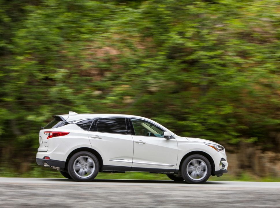 2019 Acura RDX in white driving by green trees