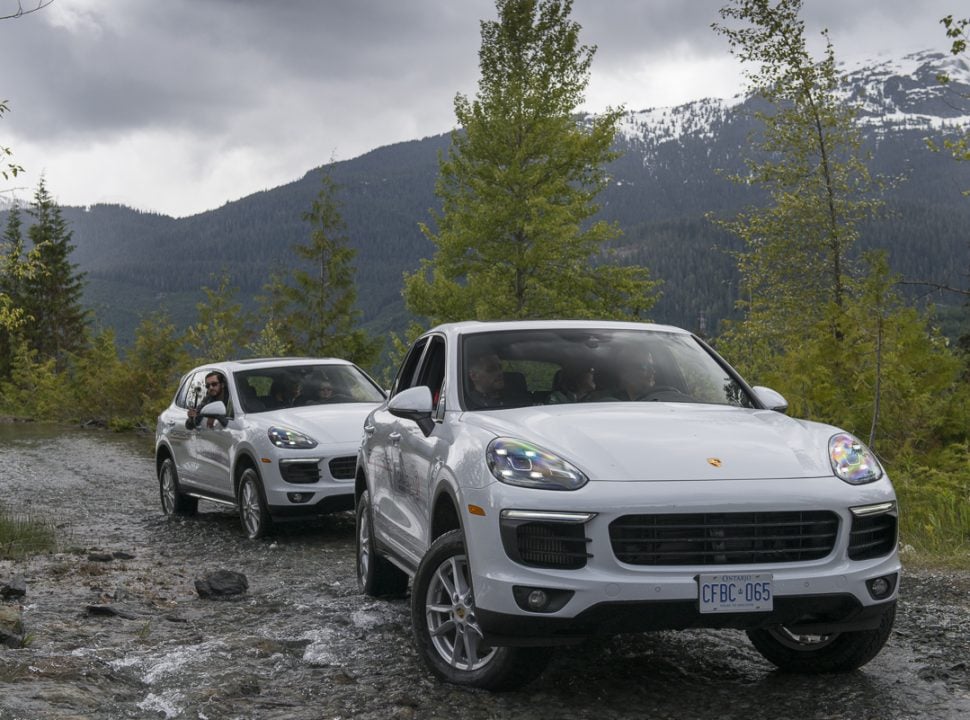 Porsche Travel Experience British Columbia Canada with two white Cayenne SUVs off roading