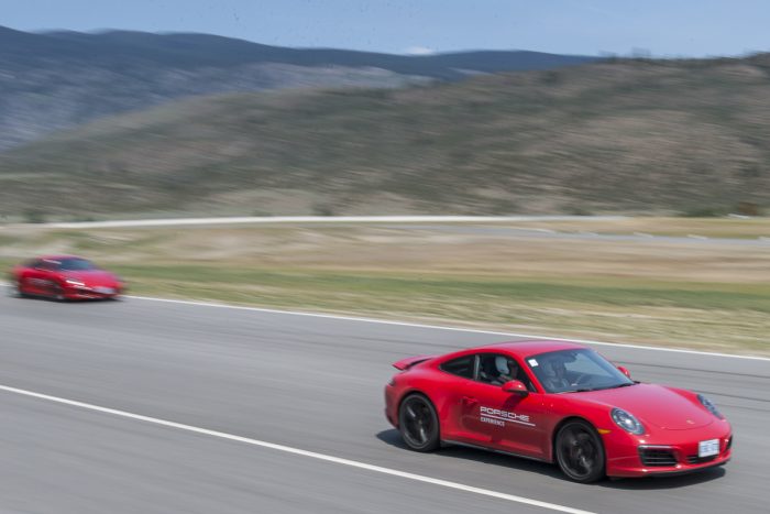 Porsche Travel Experience British Columbia Canada red 911s driving fast on the track at Area 27