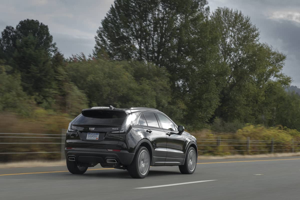 2019 Cadillac XT4 black rear view driving down highway