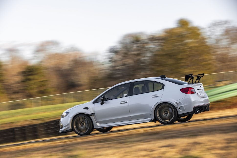 2019 Subaru STI S209 side view driving down the track with blurred background