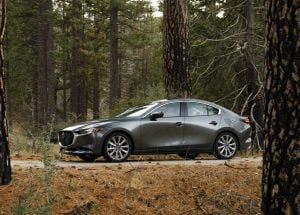 2019 Mazda3 sedan front sideview parked on road in forest
