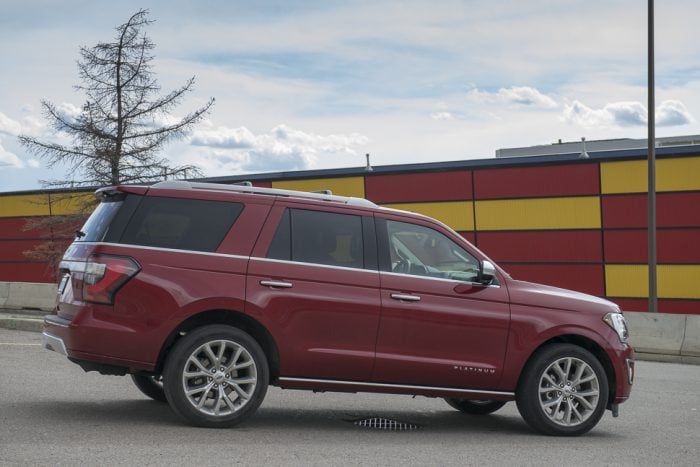 red 2019 Ford Expedition Platinum rear side view parked on road