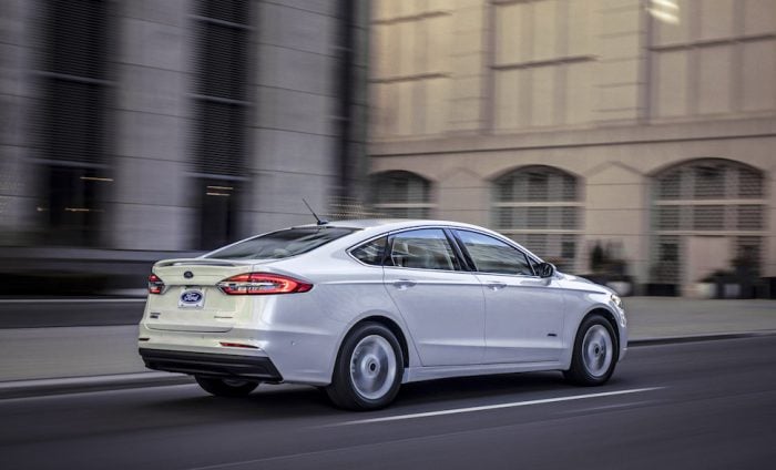 2019 Fusion Energi rear view rolling on the street in white