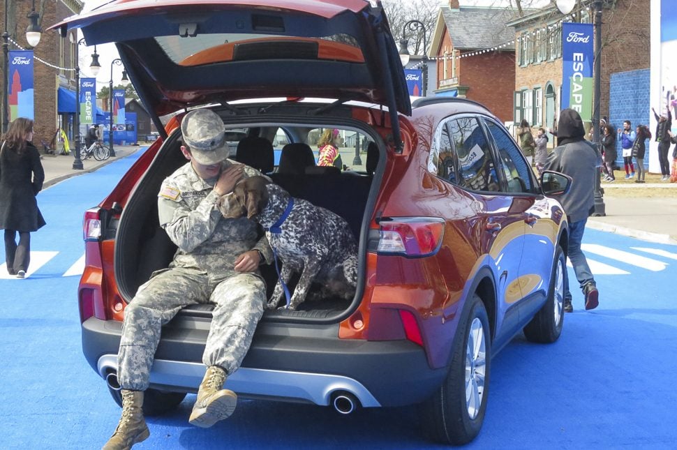 2020 Ford Escape trunk open with man and dog sitting in it