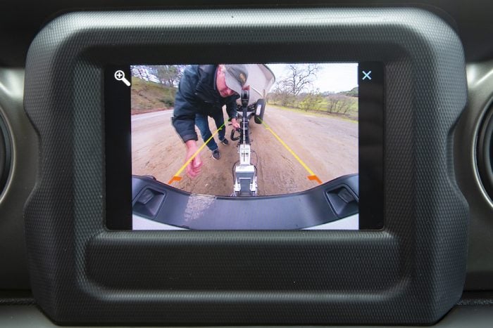 2020 Jeep Gladiator towing a boat with backup camera