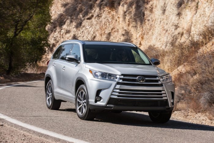 2019 Toyota Highlander XLE front view in silver driving down road