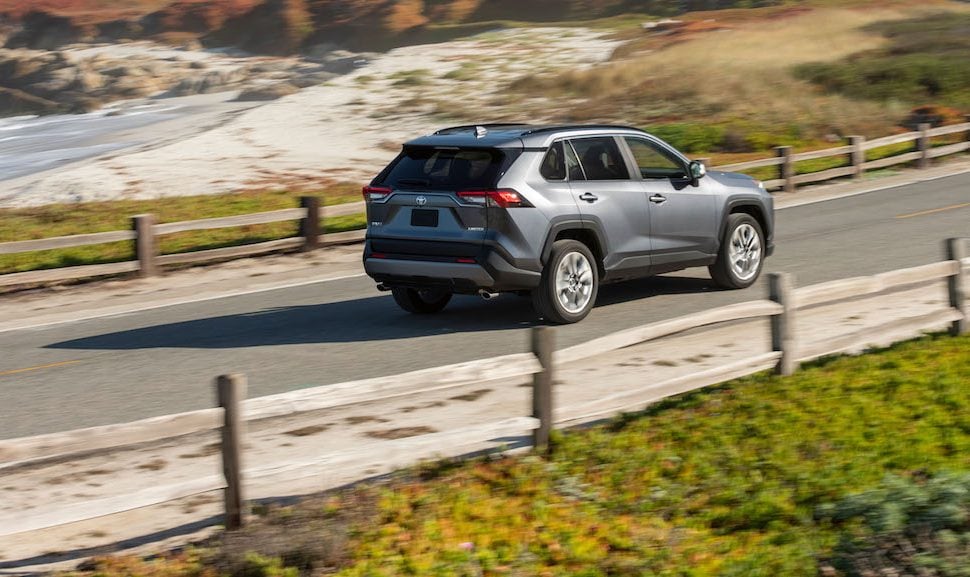 2019 Toyota RAV4 Limited rear shot driving on road by the beach