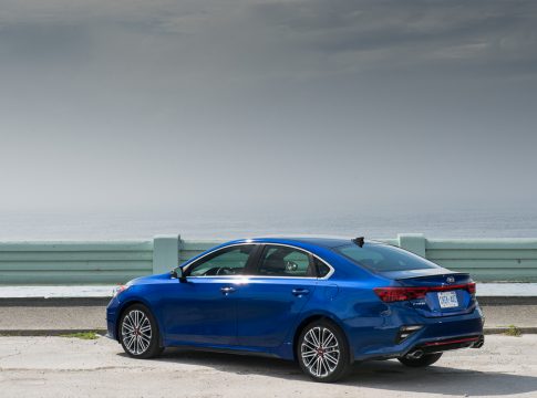 2020 Kia Forte GT rear view in blue by ocean