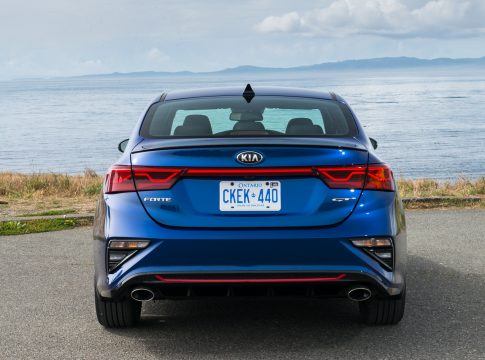 2020 Kia Forte GT rear view of blue car by ocean