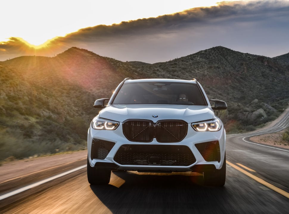 2020 BMW X5 M front grill view while driving at sunset