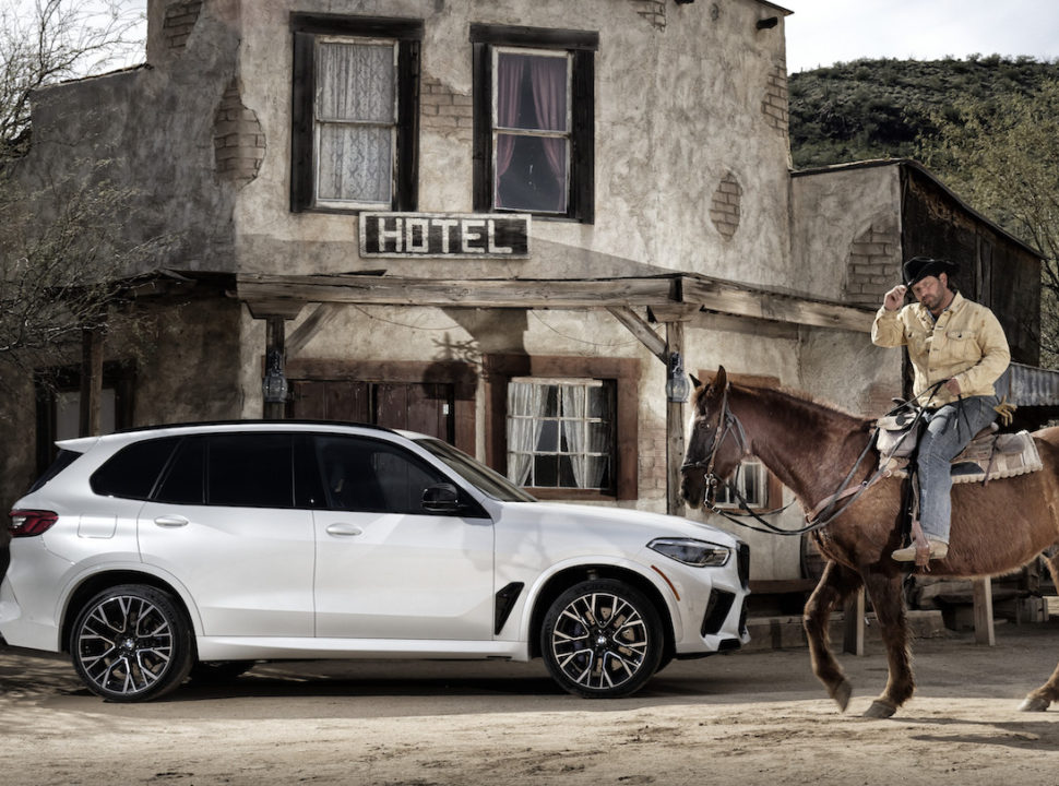 2020 BMW X5 M in front of a saloon with cowboy on horse