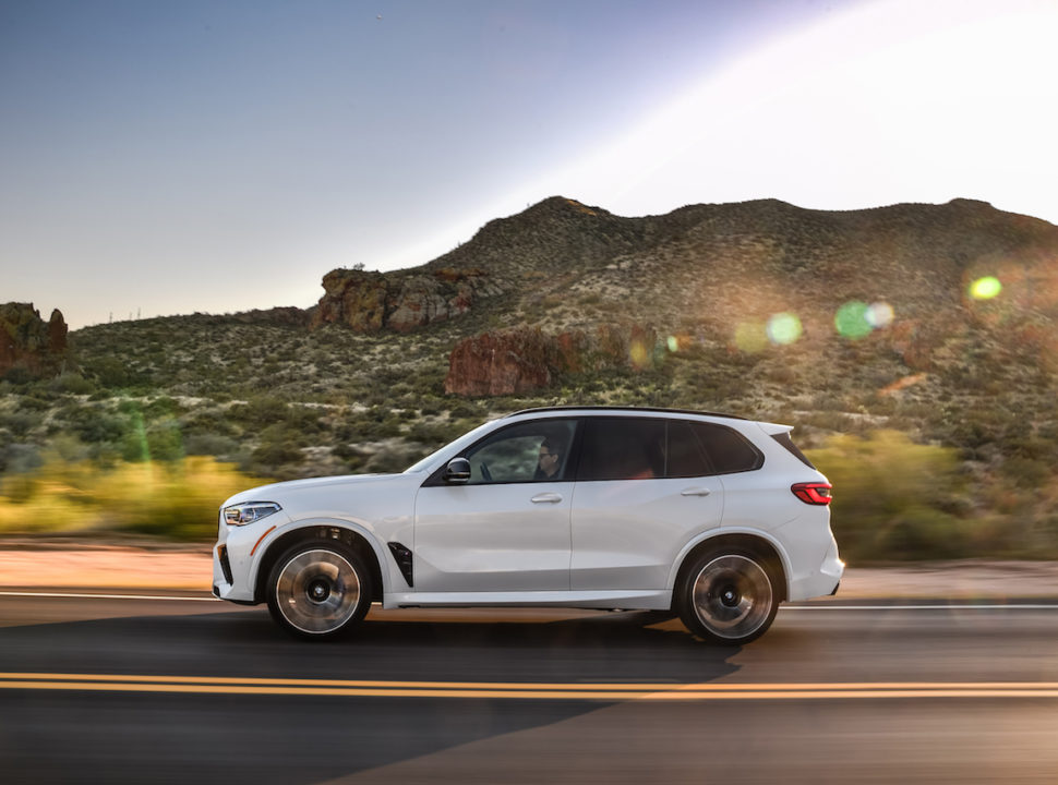 2020 BMW X5 M driving fast at sunset