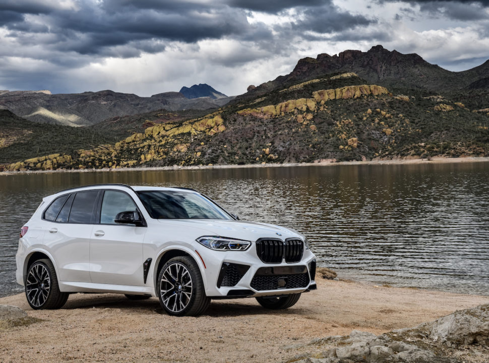 2020 BMW X5 M parked in front of lake