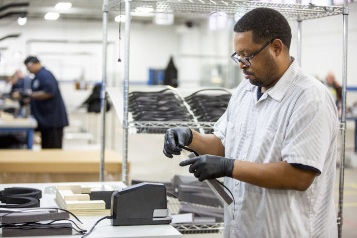 Operators and assemblers assemble medical face shields.