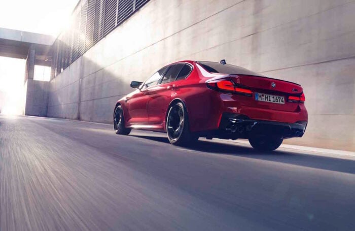 red 2021 BMW M5 Competition rear driving in red