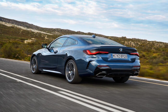 2021 BMW 4 Series Coupe driving fast on the road rear view