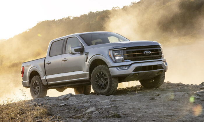 Silver 2021 Ford F-150 Tremor front view parked on rocks with dust in the back