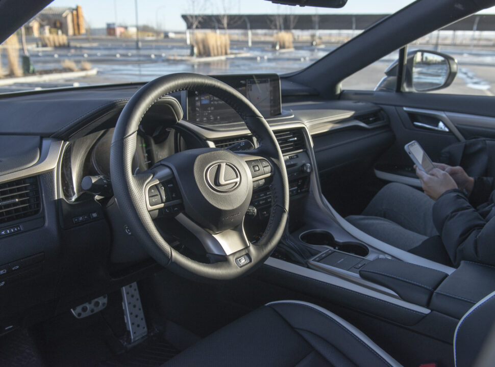 2021 Lexus RX 350 Black Line interior with passenger holding phone