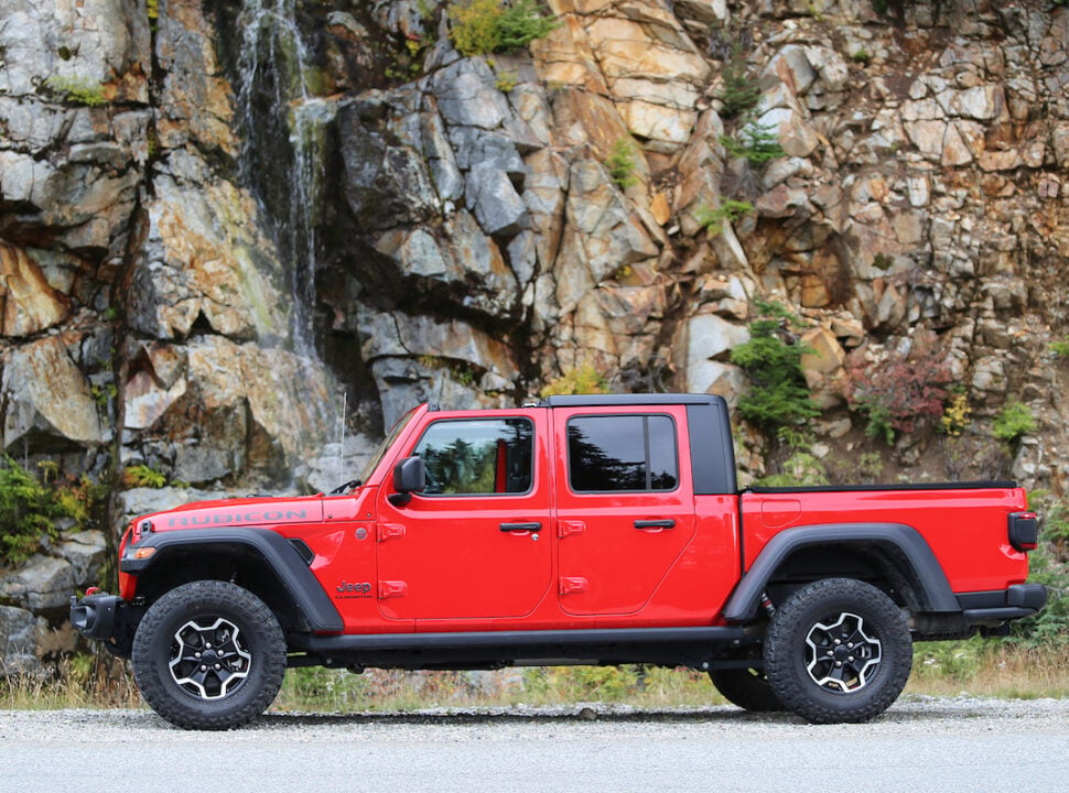 2021 Jeep Gladiator Rubicon sideview parked by small waterfall