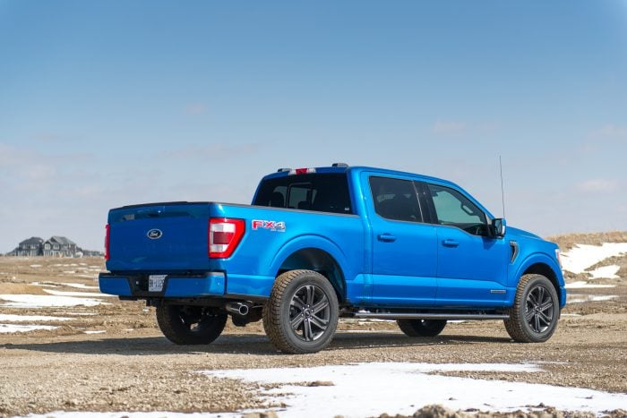 2021 Ford F-150 Lariat Hybrid in blue parked on gravel road