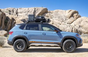VW Taos Basecamp Concept side view parked in front of large rocky cliff