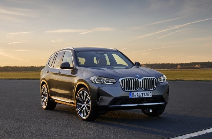 2022 BMW X3 xDrive front view parked on street at sunset 