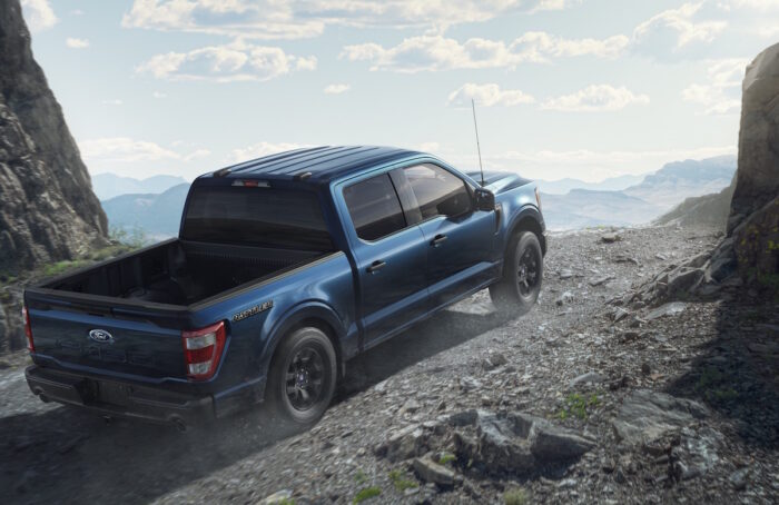 blue 2023 Ford F-150 Rattler rear view off roading