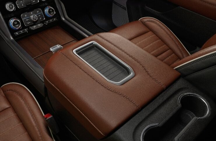 The full grain leather trim washes over the center console storage area.