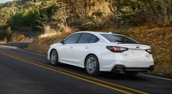 white 2023 Subaru Legacy rear shot driving on the road